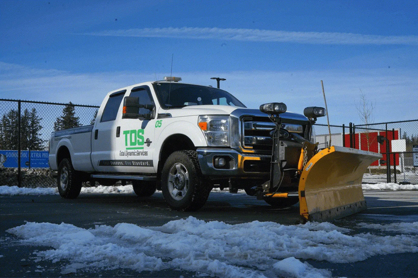 TDS plow truck clearing snow from a commercial property in the Lower Mainland during winter