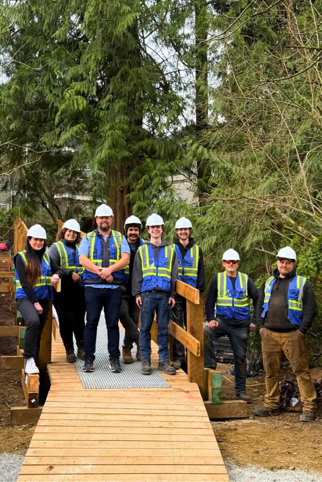 The TDS Civil crew in hardhats and hi-vis gear on a completed pedestrian bridge project